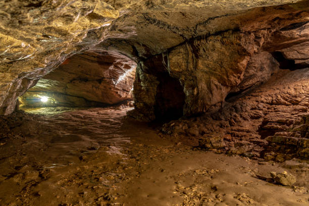 istock View inside the ancient cave with stone walls with additional lighting. Texture of a stone wall in a cave. 1137596989