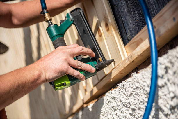 istock Construction worker installing wooden planks on house facade 1137600011
