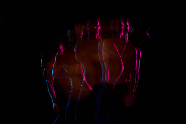 istock Shirtless man dancing with color gel lights 1137601152
