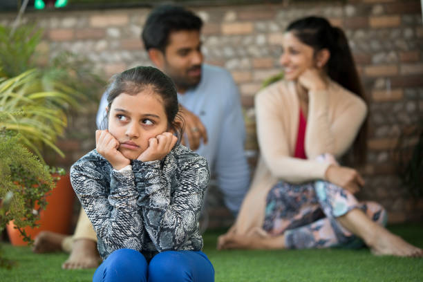 istock Bored daughter with parents busy in each other 1137601475