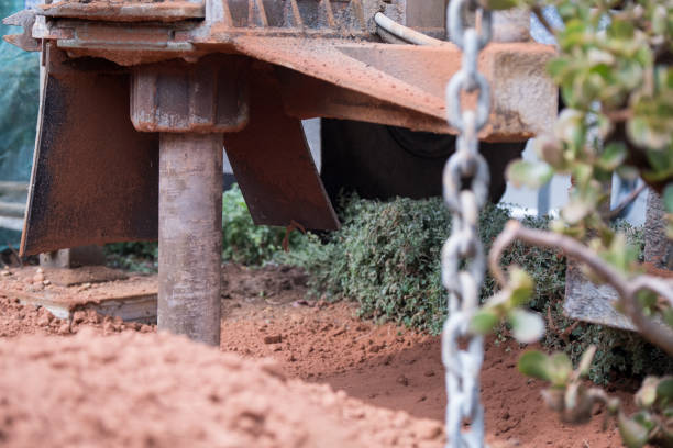 drilling machine slowly digs a borehole in a domestic garden in cape town - drill borehole mining rock imagens e fotografias de stock