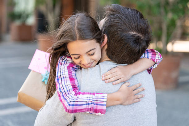 istock Loving daughter hugging daddy for father's day after giving him a present and card 1137603131