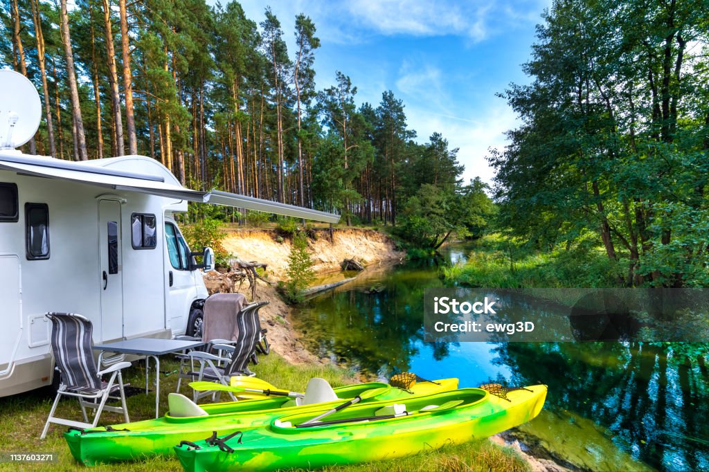 Summer vacation with a camper by the river Summer vacation with a camper by the river Wda, Kashubia, Poland Motor Home Stock Photo