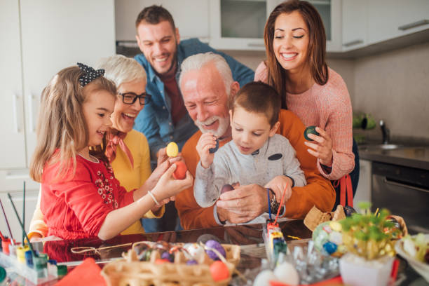 istock Smiling family holding colorful Easter eggs 1137604531