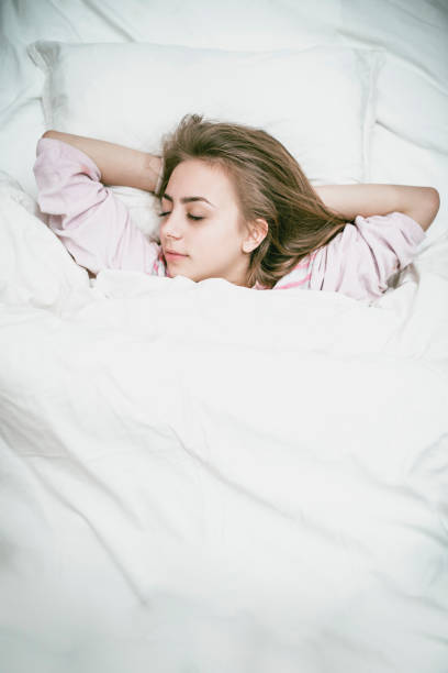 istock Cute Girl Sleeping In Cozy Bed 1137607181