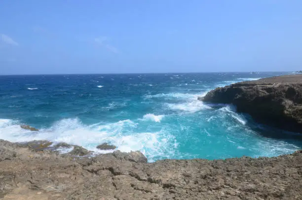 Aruba's east coast has crashing waves against lava rock.