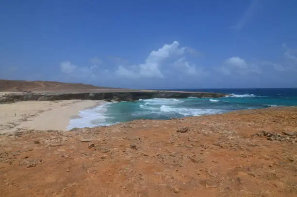 Aruba's Daimari beach with waves crashing ashore.