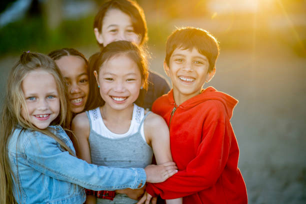 istock Friends hugging on the beach 1137610274