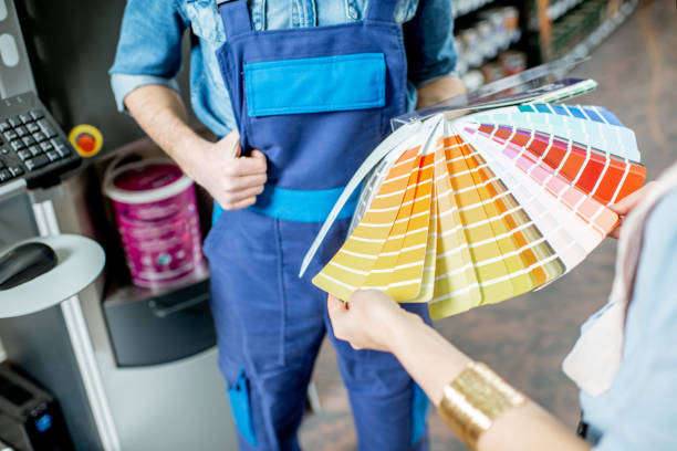 Choosing paints in the building shop Choosing paint from color swatches in the building shop, close-up view mixing stock pictures, royalty-free photos & images