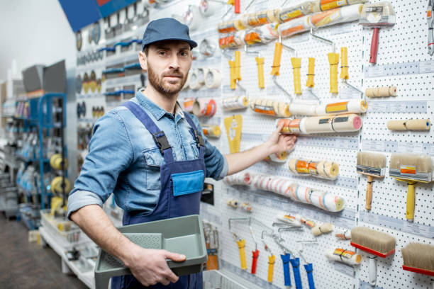 istock Man choosing tools for painting in the shop 1137610516