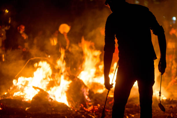 Silhouette of people in front of fire roasting grain for Holi Lohri festival stock photo