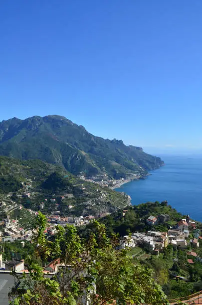 A scenic view looking down the rolling hills and winding roads of Amalfi in Italy.
