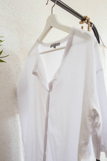istock White blouse on a hanger on white background. close up. 1137613694