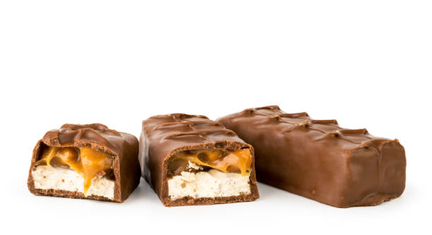 istock Chocolate Snickers and two halves on a white, isolated. 1137614286
