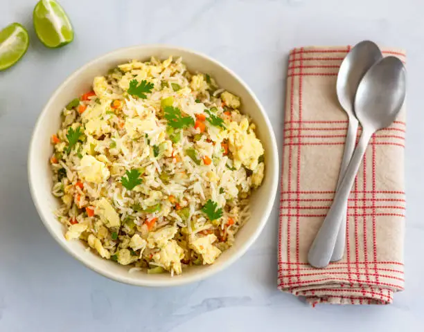 Egg Fried Rice with Vegetables in a Bowl - Directly from Above. Chinese Fried Rice, Chinese Cuisine, Comfort Food Concept.