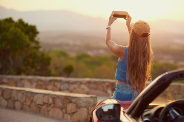 istock Young female traveller having fun with convertible car 1137618476