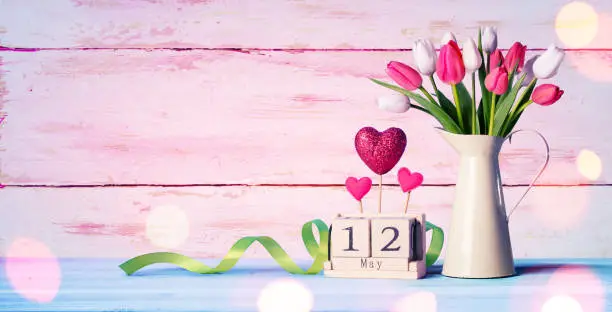Tulips And Calendar On wooden Table
