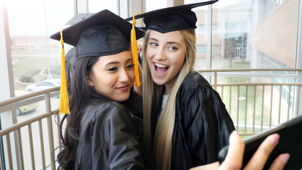 istock Female best friends take selfie during graduation 1137620138