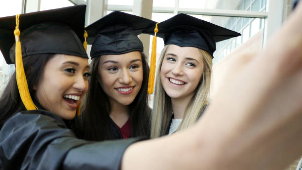 istock Three young women take graduation selfie 1137620141