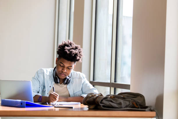 istock Teenage boy studies in the campus library 1137620171