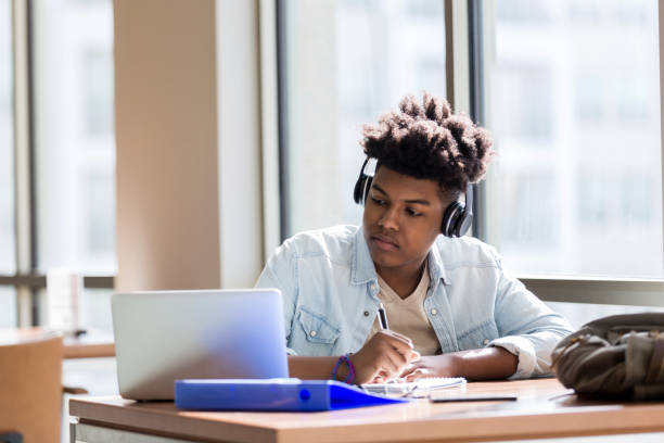 istock High school student uses laptop in school library 1137620174