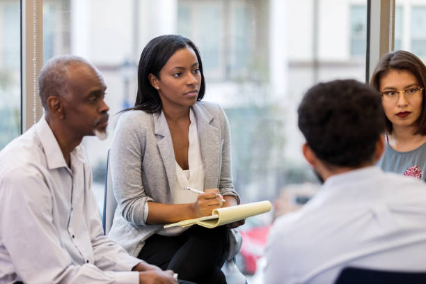 istock Female counselor listens during group session 1137620250