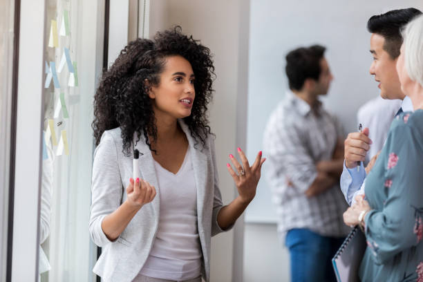 istock Young businesswoman leads brainstorming session at work 1137620313