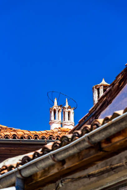 istock Beautiful chimneys on a rooftop against cloudless sky 1137622396