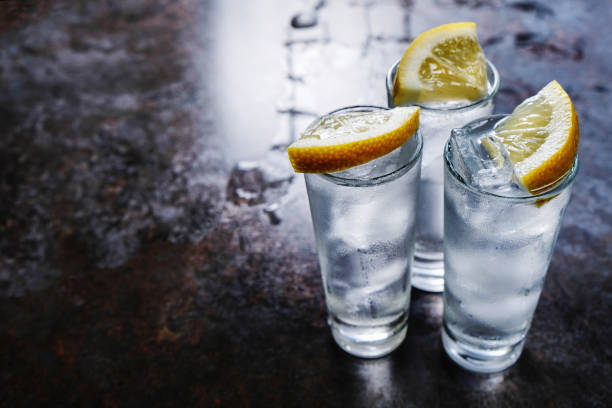 istock Vodka in shot glasses on stone table 1137625276