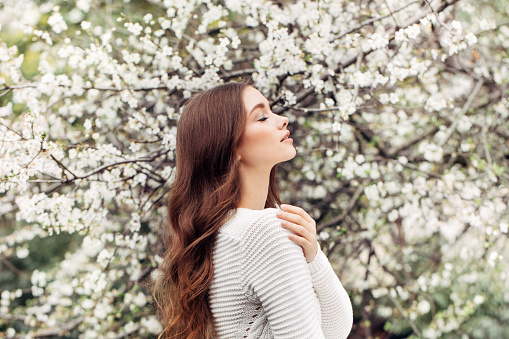 Beautiful girl on the background of spring bush