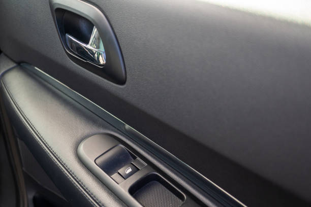 istock Car interior details of door handle with windows controls. Car window controls and details 1137628450