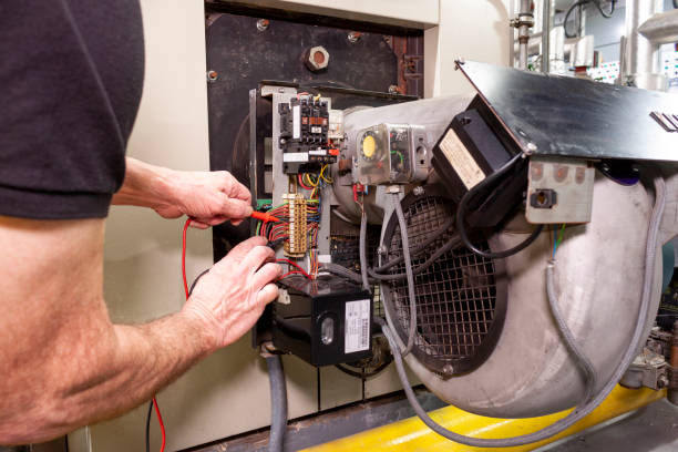 istock Industrial boiler engineer using a tester to check wiring 1137630309
