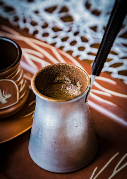 Old cezve coffee turkish pot with strong black turkish coffee. Selective focus.