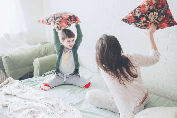 istock Pillow fight.Mother and son 1137632446