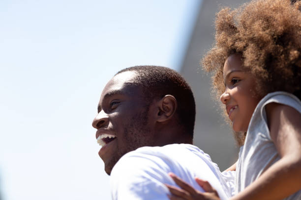 istock Close up smiling African American father having fun with daughter 1137632780