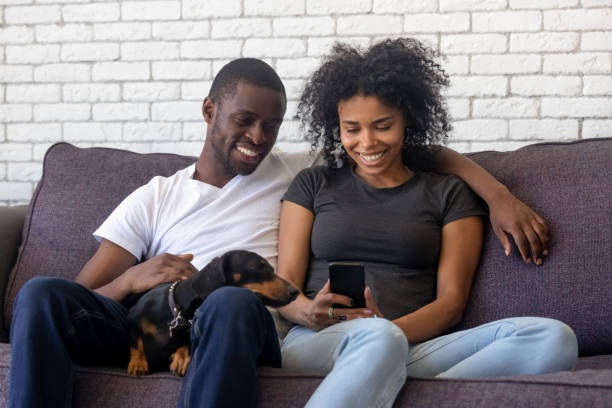 istock Smiling African American couple using phone, surfing internet 1137632818