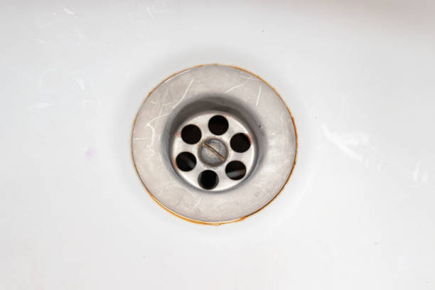 istock A sink drain hole with limescale or lime scale and rust on it, dirty rusty bathroom washbowl 1137634523