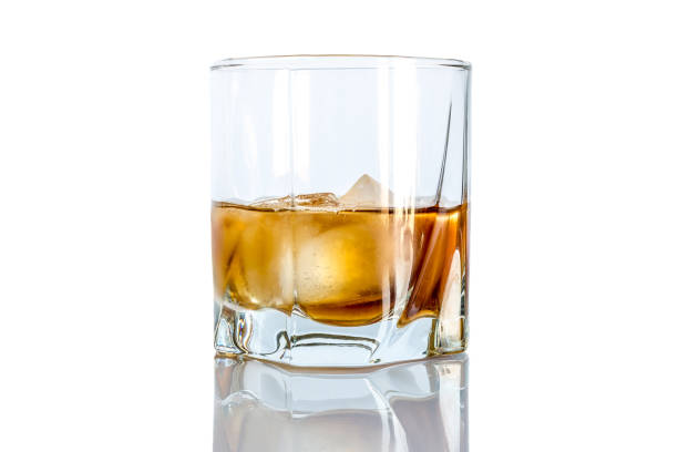 istock Whiskey with ice close-up in a glass isolated on a white background 1137634587