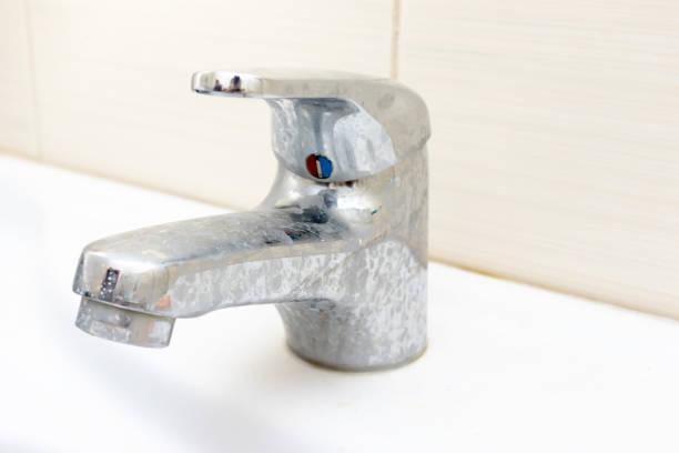 dirty faucet with limescale, calcified water tap with lime scale on washbowl in bathroom - water pipe rusty dirty equipment imagens e fotografias de stock