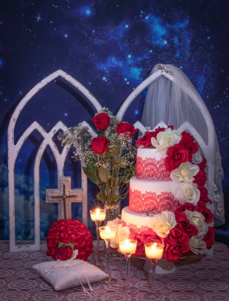 istock Wedding Cake with Red Roses, Wedding Rings, Candles  and Arched Window 1137638159