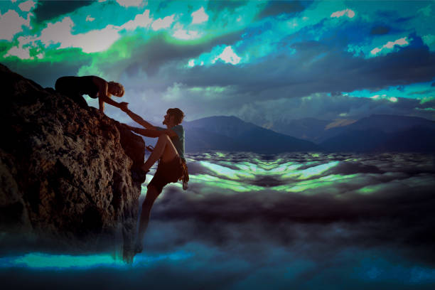 istock Teamwork couple helping hand trust in inspiring mountains 1137640115