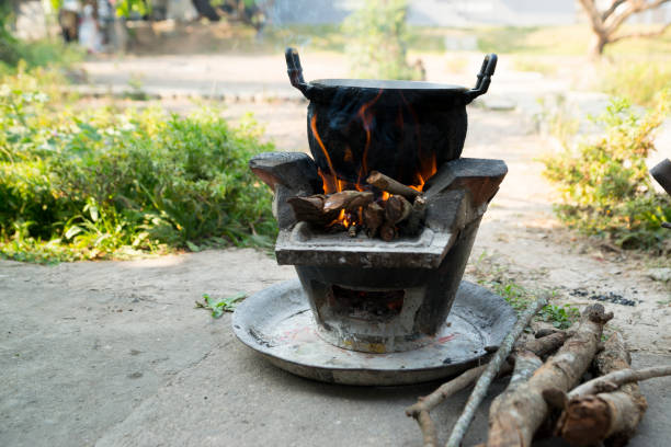 istock Old cooking pot stove using firewood As fuel. 1137640935