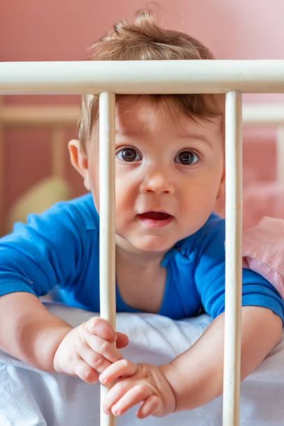 istock Baby boy in his crib 1137640984