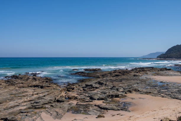 istock Summer Concept: Rocky Shore and Ocean Waves Shot on a Summer Day 1137645393