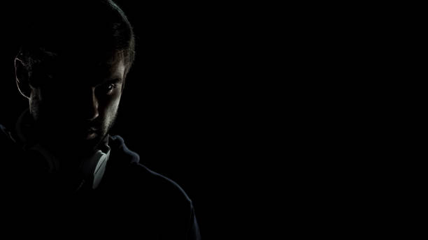 istock Terrorist spy with headphones looking suspiciously at camera, data leak risk 1137645517