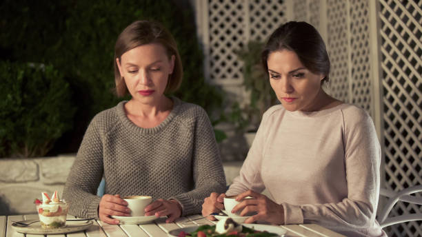 istock Sad young women thinking of problem sitting in cafe, sisters misunderstanding 1137646033