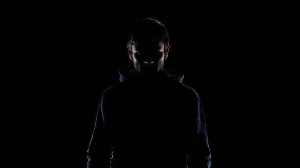 istock Black silhouette of mysterious man wearing hood, intention to commit crime 1137646094