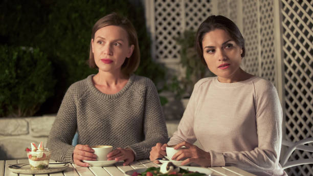 istock Two offended ladies sitting in cafe, not willing to apologize and communicate 1137646207