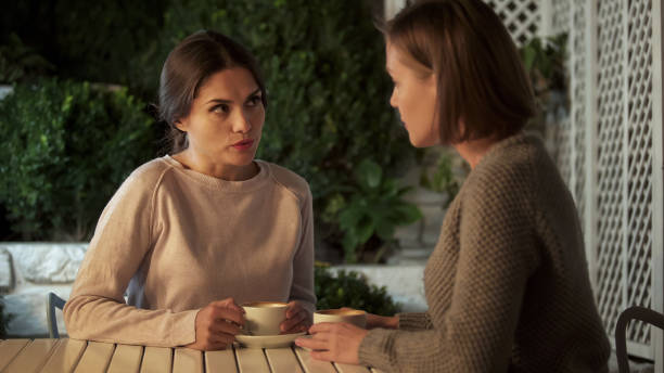 istock Young beautiful women talking, drinking coffee on terrace, friendship relations 1137646376