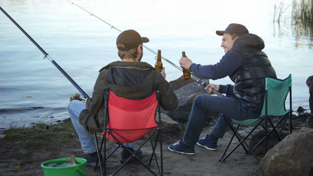 two friends fisherman fishing and drinking beer, resting weekend, good company - business styles foods and drinks drinking imagens e fotografias de stock